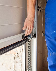 A male hand lifts up garage door